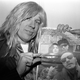 Michael McKean as David St. Hubbins holds up a copy of NME